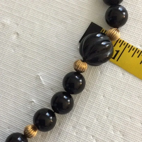 Woman’s Onyx Necklace Showcases a striking combination of black & gold bead